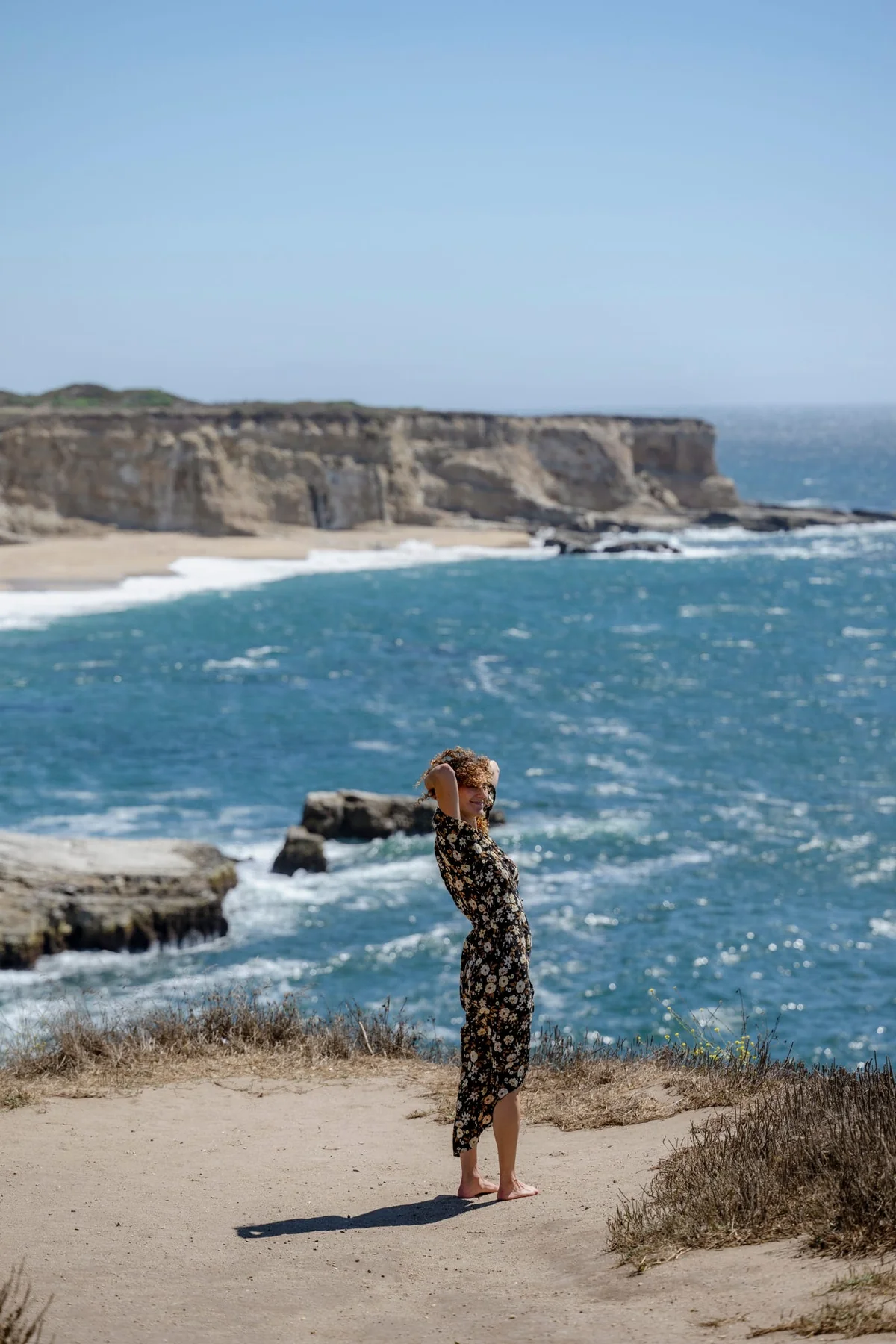 Lee Lewis standing on a coastal bluff above the ocean